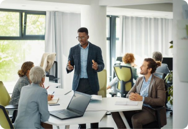 Man discussing in front of three people