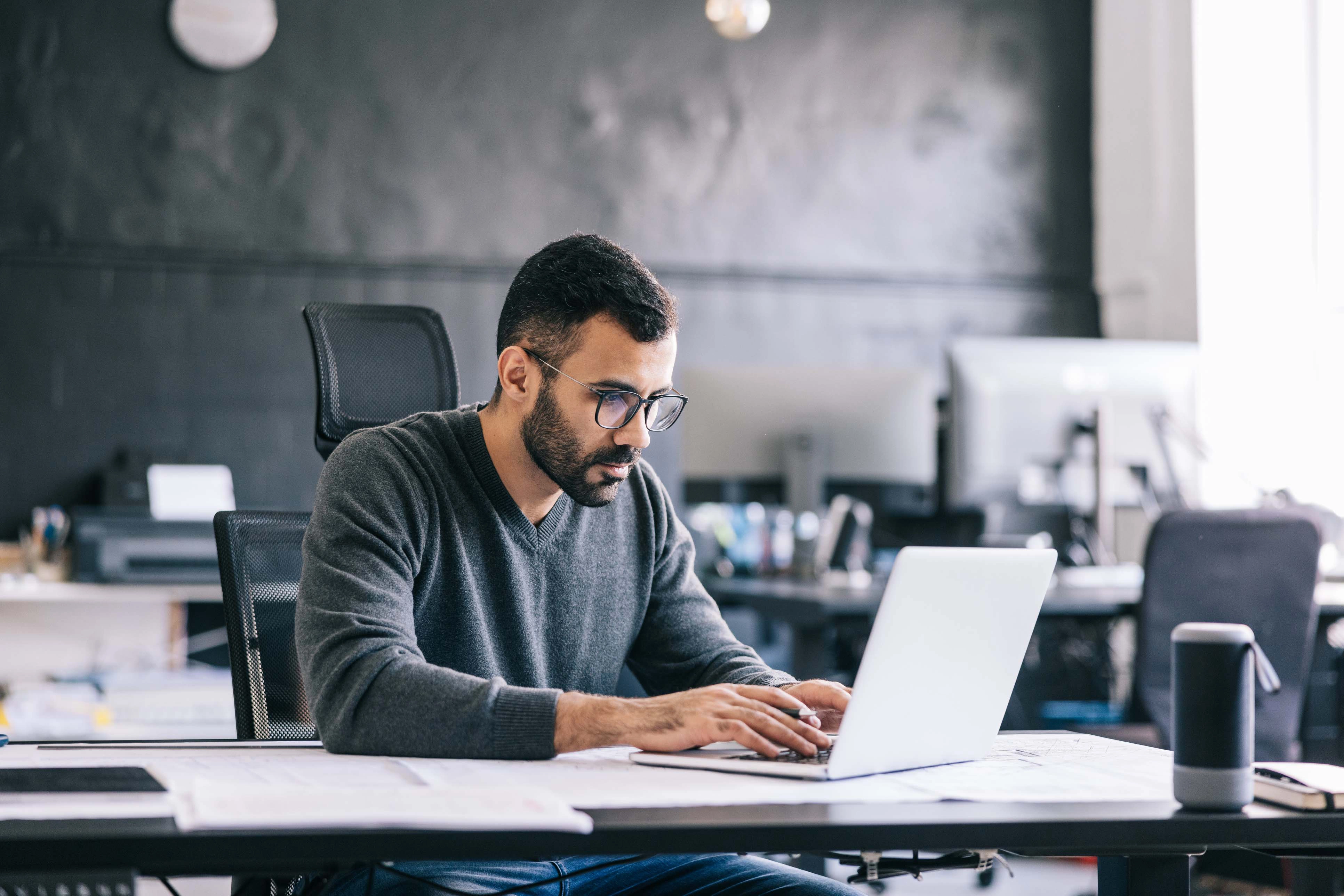 Man typing on laptop