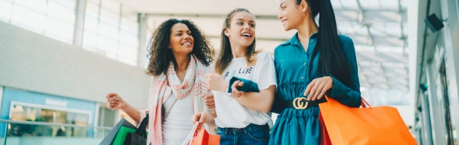 Three women with shopping bags